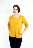 Three-quarter length sleeve breastfeeding shirt in trendy mustard color. Made with a buttery-soft viscose blend. Designed in the US. 